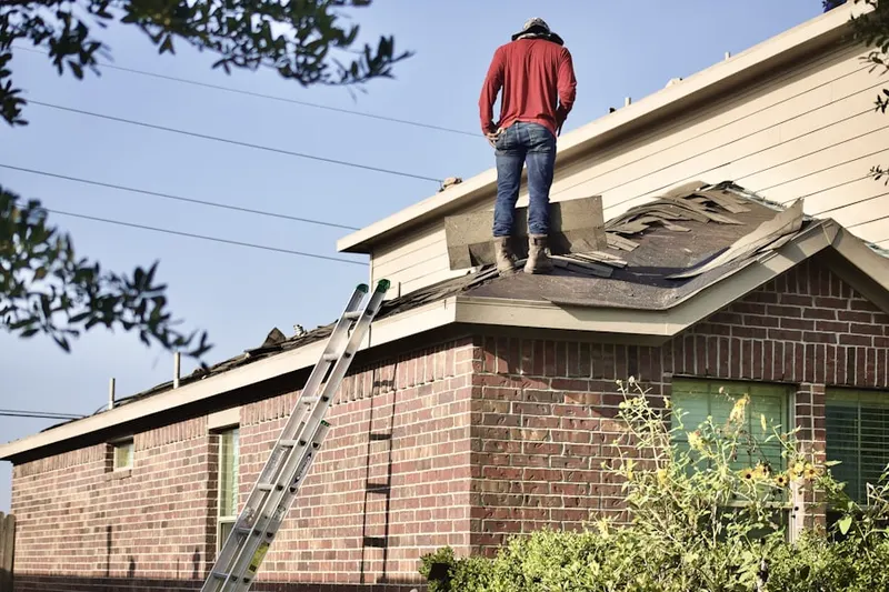 Professional roofer working on a residential roof in Kayenta